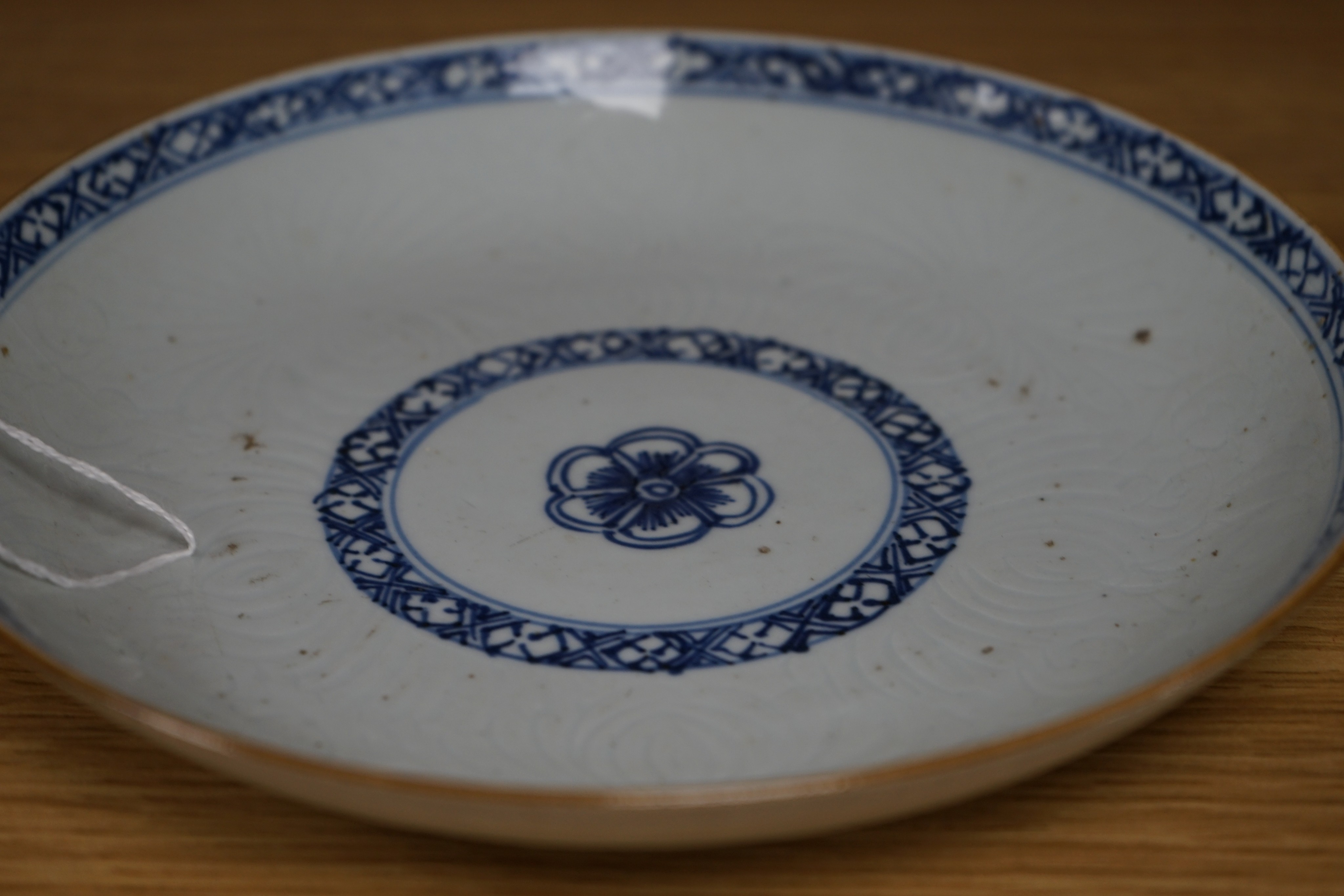 An 18th century Chinese shallow circular blue and white dish with incised decoration, Dia 22cm